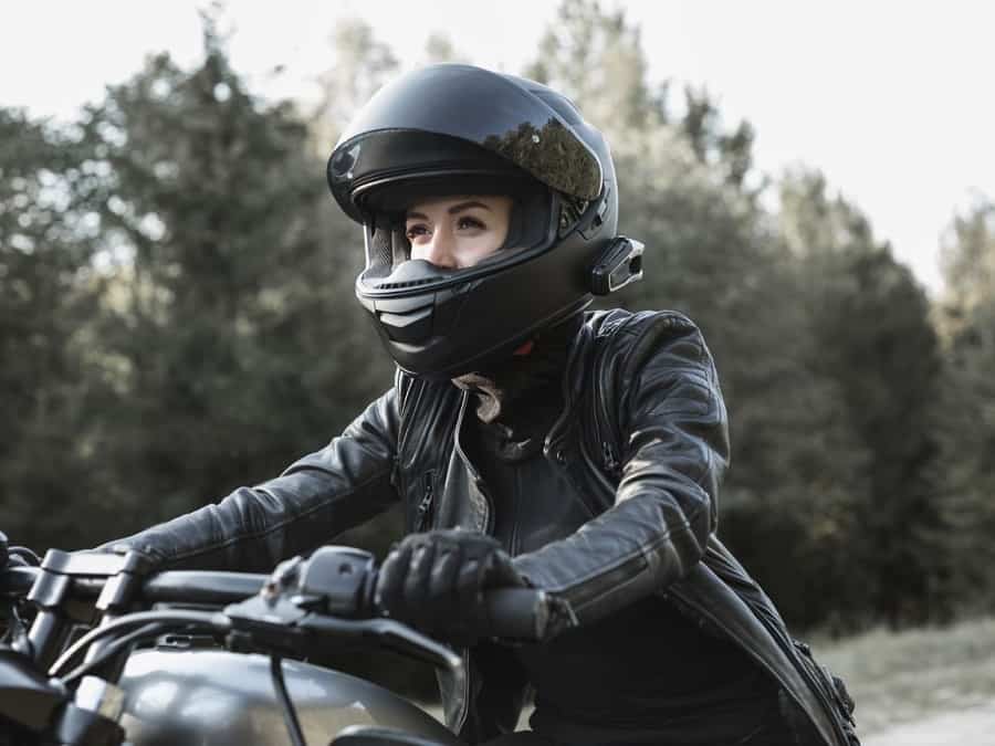 Motorcycle rider with Bluetooth bike to bike intercom on helmet.